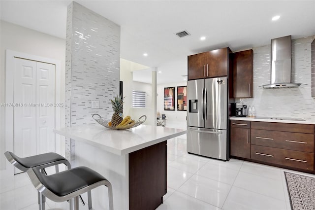 8851 SW 208th Ter, Cutler Bay, FL 33189 - kitchen with a kitchen breakfast bar, wall chimney range hood, light countertops, modern cabinets, and stainless steel fridge with ice dispenser