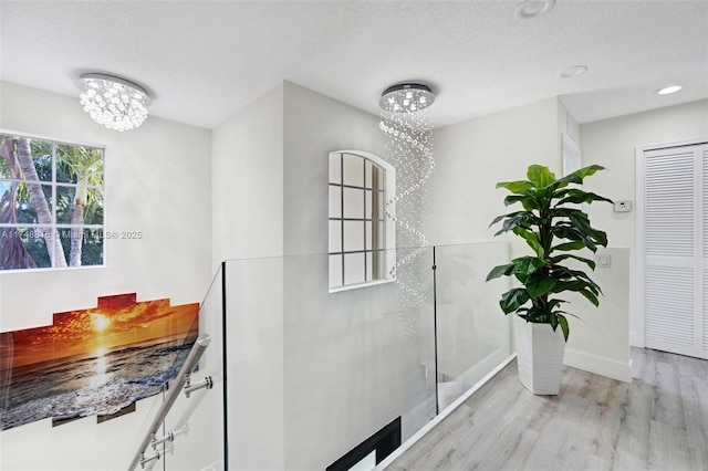 8851 SW 208th Ter, Cutler Bay, FL 33189 - interior details with a textured ceiling, an inviting chandelier, baseboards, and wood finished floors