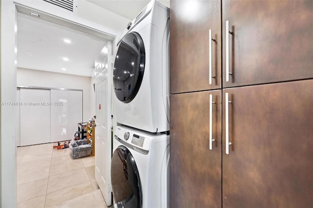 8851 SW 208th Ter, Cutler Bay, FL 33189 - washroom featuring visible vents, stacked washer / drying machine, light tile patterned floors, cabinet space, and recessed lighting