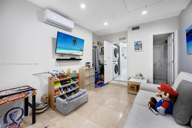 8851 SW 208th Ter, Cutler Bay, FL 33189 - playroom featuring visible vents, a wall mounted air conditioner, stacked washing maching and dryer, and tile patterned flooring