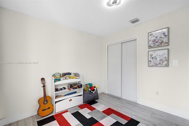 8851 SW 208th Ter, Cutler Bay, FL 33189 - game room featuring visible vents, baseboards, wood finished floors, and a textured ceiling