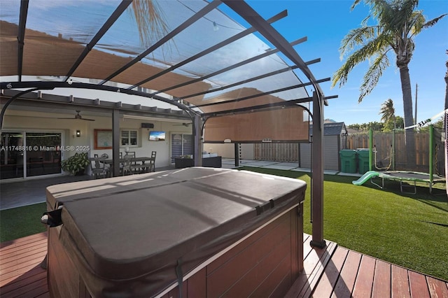 8851 SW 208th Ter, Cutler Bay, FL 33189 - wooden deck featuring a lawn, a trampoline, a shed, a hot tub, and a pergola