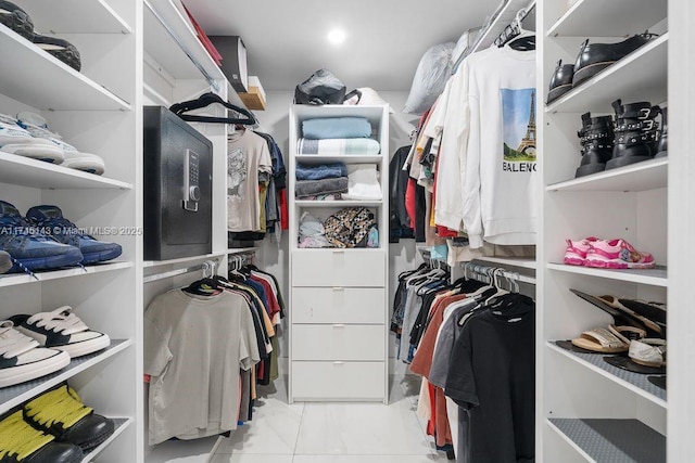 spacious closet featuring marble finish floor