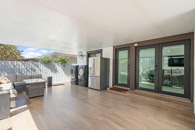 view of patio featuring french doors, outdoor lounge area, and washing machine and dryer