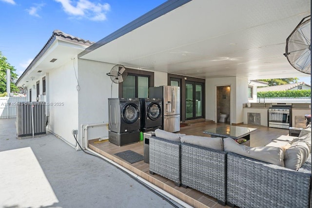 view of patio with washer and dryer, outdoor lounge area, and area for grilling