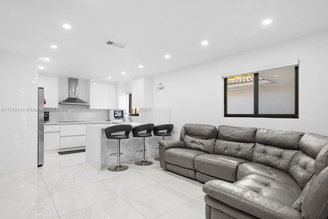 living room featuring visible vents and recessed lighting