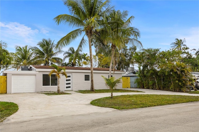 view of front of property with an attached garage, concrete driveway, and stucco siding