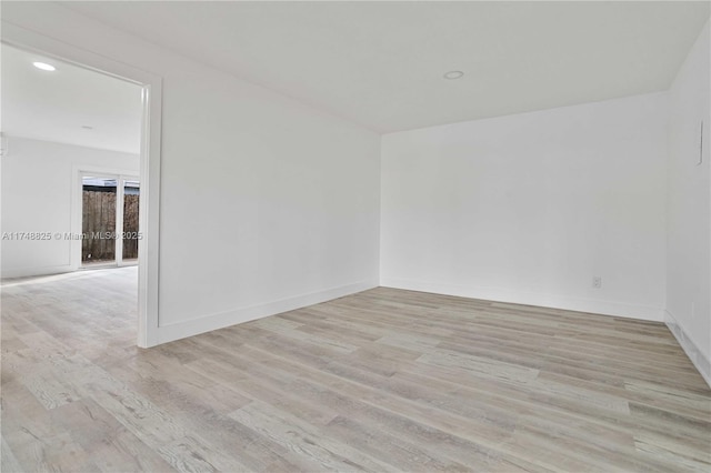 unfurnished room featuring recessed lighting, light wood-style flooring, and baseboards