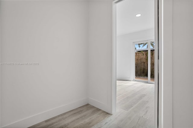 empty room with recessed lighting, baseboards, and light wood finished floors