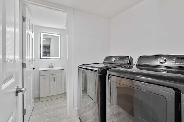 laundry area featuring laundry area, washer and clothes dryer, and a sink