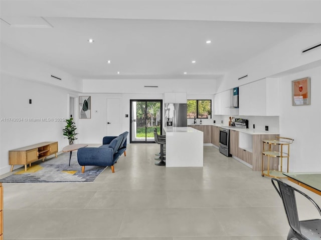 living area with recessed lighting and visible vents