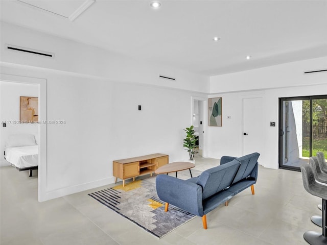 living area with recessed lighting, visible vents, and baseboards