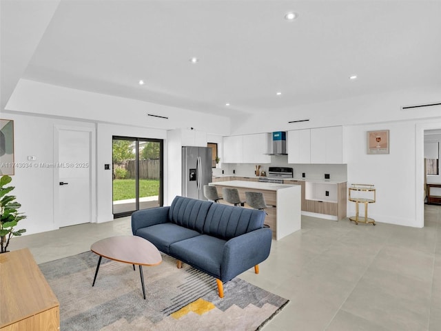 living room featuring recessed lighting and baseboards