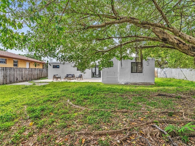 back of house featuring stucco siding, a patio, and a fenced backyard