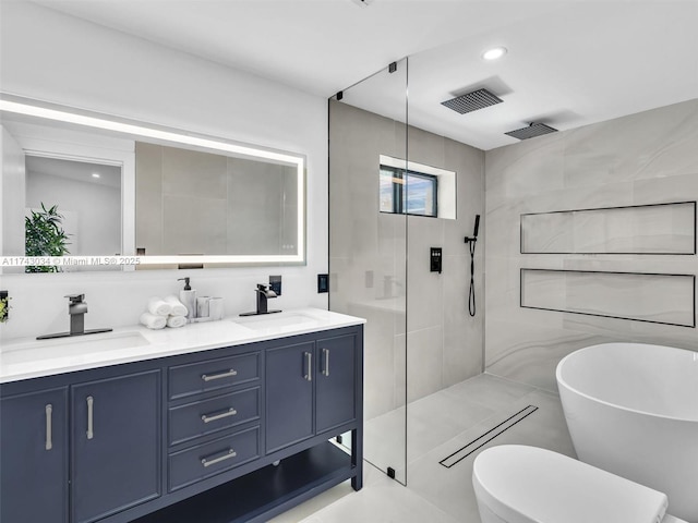 bathroom with double vanity, a walk in shower, tile walls, and a sink