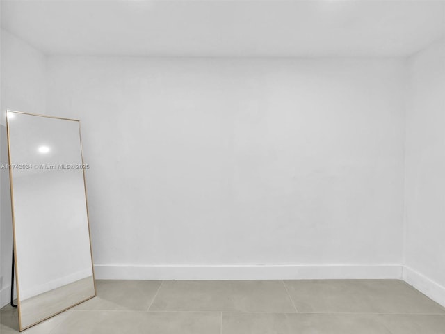 unfurnished room with baseboards