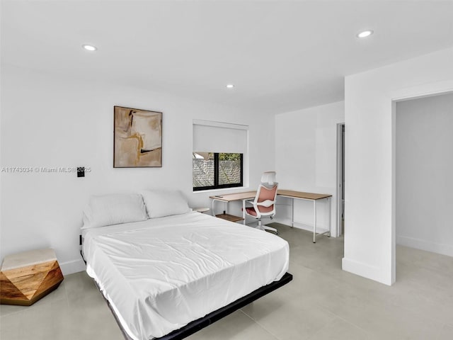 bedroom featuring recessed lighting, baseboards, and finished concrete floors