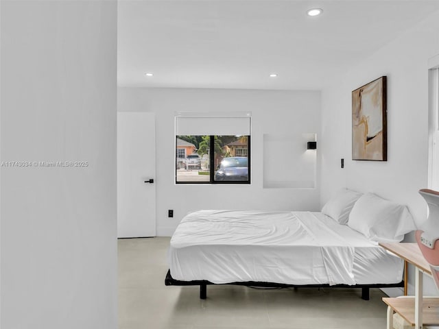 bedroom with recessed lighting and concrete floors