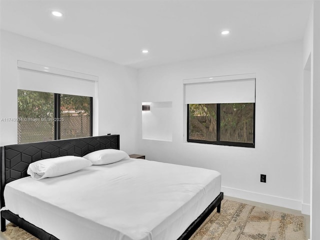 bedroom with recessed lighting and multiple windows