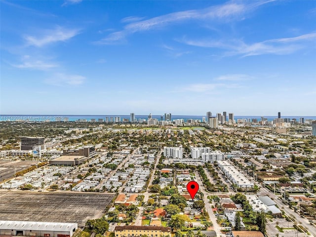 birds eye view of property with a city view and a water view