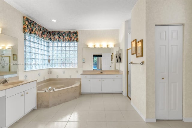 full bath featuring a closet, two vanities, and a sink