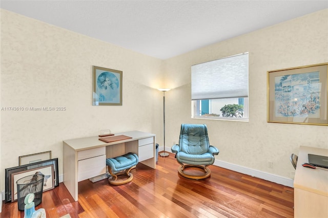 home office featuring wood finished floors and baseboards