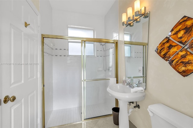 full bathroom with a stall shower, tile patterned flooring, and toilet