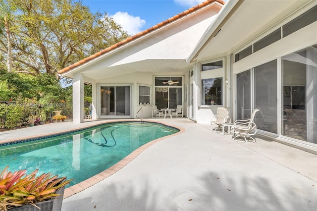 outdoor pool featuring a patio and fence