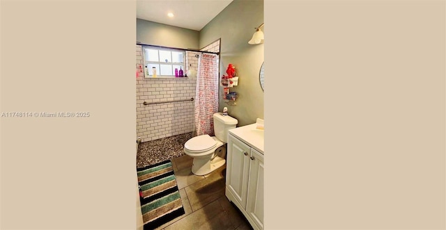 bathroom featuring tile patterned floors, tiled shower, toilet, and vanity