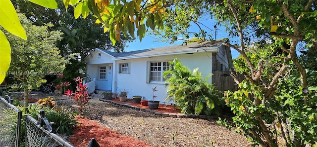 exterior space with fence and stucco siding