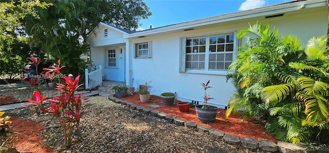 view of exterior entry with stucco siding