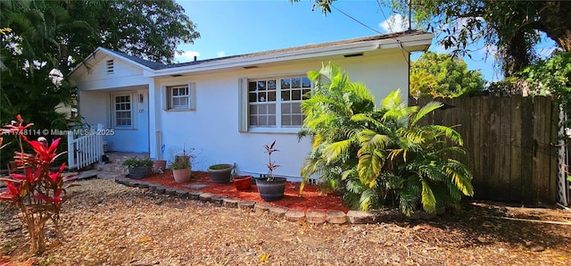 exterior space featuring fence and stucco siding