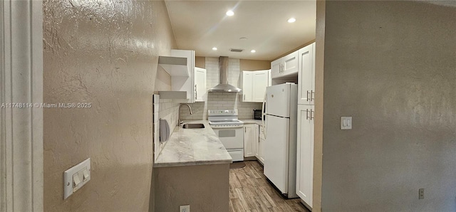 kitchen with open shelves, backsplash, wall chimney range hood, white appliances, and wood finished floors