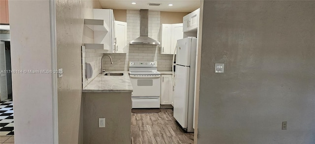 kitchen featuring white appliances, open shelves, backsplash, a sink, and wall chimney exhaust hood