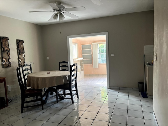 dining area featuring light tile patterned floors and a ceiling fan