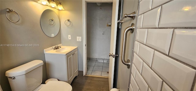 bathroom with tile patterned floors, vanity, and toilet
