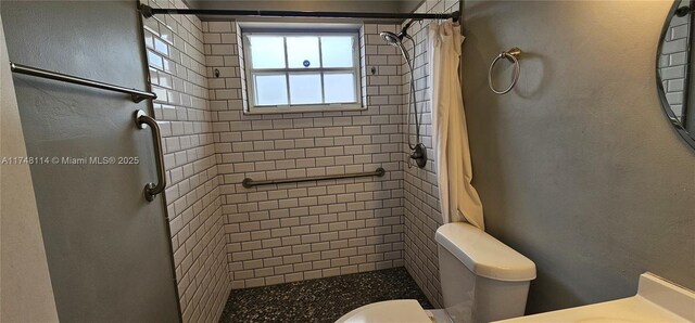 full bathroom featuring a shower stall and toilet