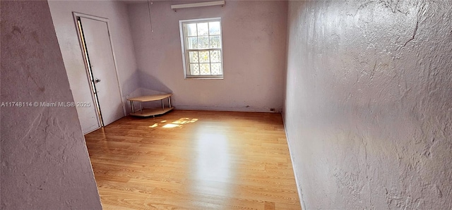 spare room featuring wood finished floors