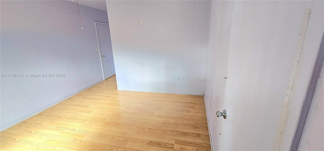unfurnished room with wood finished floors