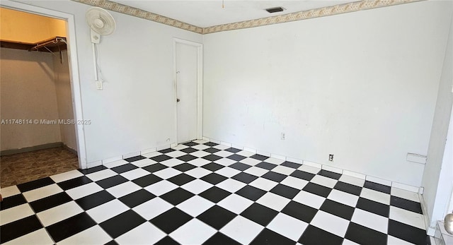 unfurnished bedroom with visible vents, light floors, and a closet