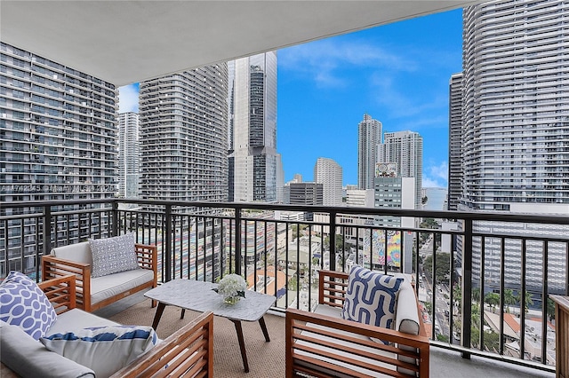 balcony featuring a view of city and outdoor lounge area