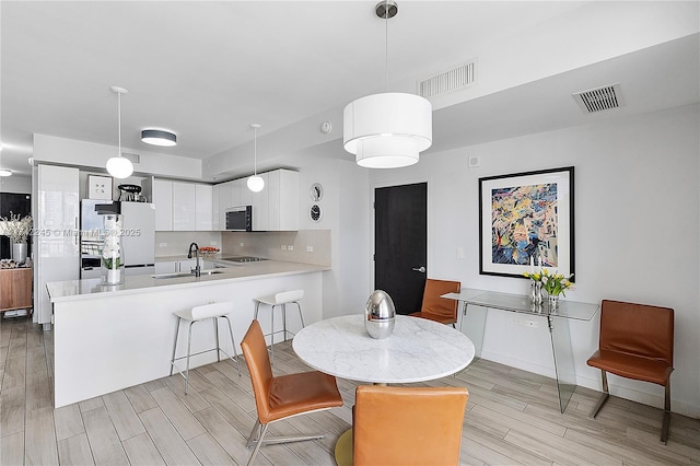 dining area with wood tiled floor and visible vents