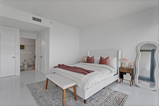 bedroom featuring light tile patterned floors, ensuite bath, and visible vents