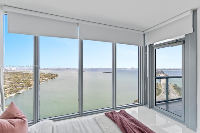 unfurnished sunroom featuring a water view