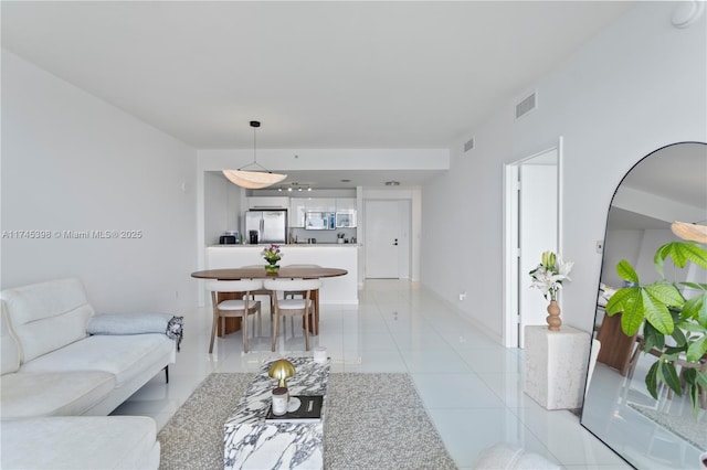 living room featuring light tile patterned floors and visible vents