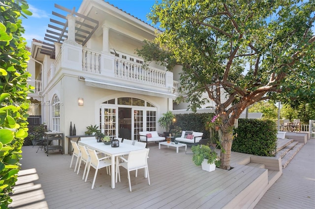 deck featuring an outdoor hangout area, outdoor dining area, and french doors