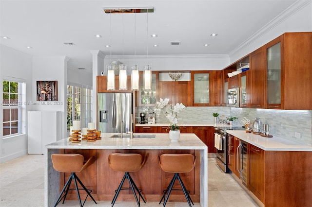 kitchen featuring light countertops, hanging light fixtures, glass insert cabinets, and stainless steel appliances