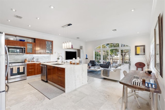 kitchen with decorative light fixtures, stainless steel appliances, open floor plan, light countertops, and glass insert cabinets