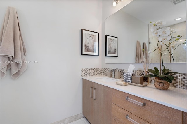 full bath with tasteful backsplash, visible vents, and vanity