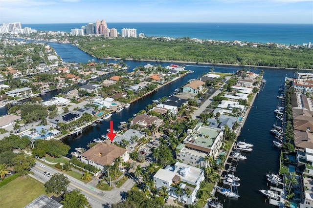 drone / aerial view featuring a view of city and a water view